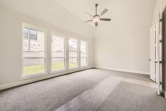 Carpeted spare room with a ceiling fan and lofted ceiling | Image 15