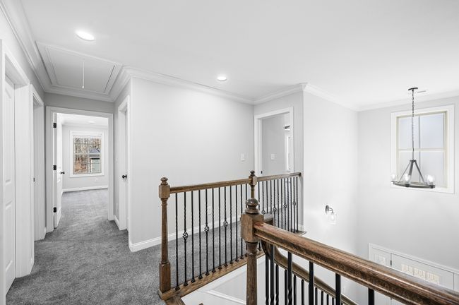 Stair Landing. with iron railing and flat ceilings throughout. | Image 43