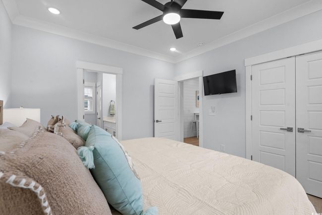 Bedroom featuring crown molding, recessed lighting, a closet, and a ceiling fan | Image 24