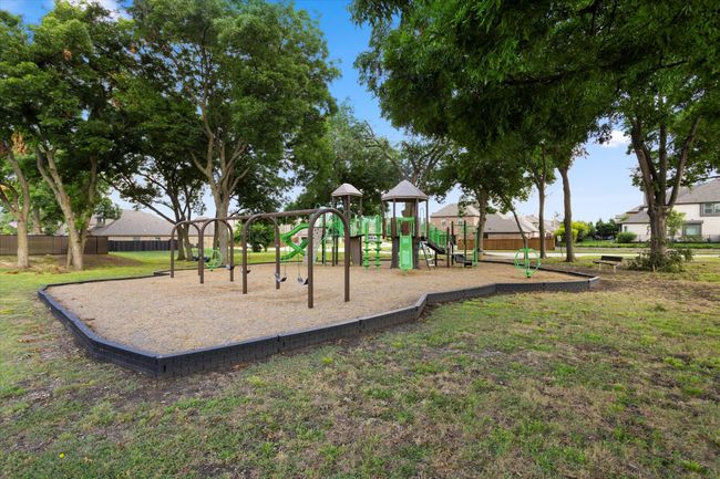 Community play area featuring fence and a lawn | Image 33