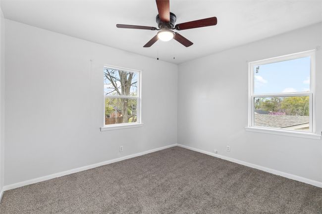 Spare room with a ceiling fan, baseboards, and carpet flooring | Image 20