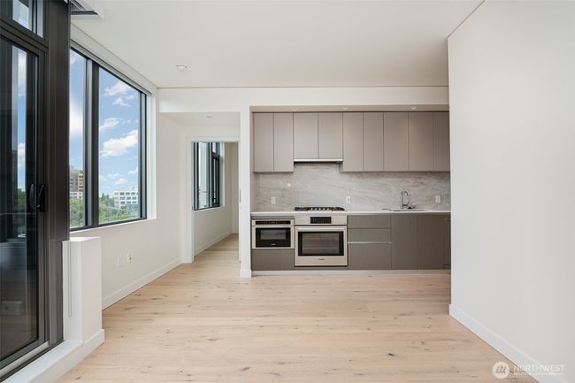 Enough space adjacent to the kitchen for a bistro dining table or floating bar. | Image 9