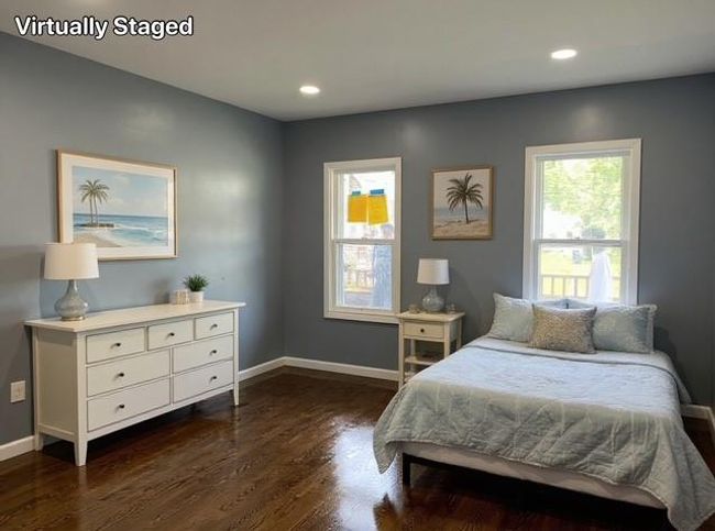 Bedroom with dark wood-type flooring and recessed lighting | Image 9