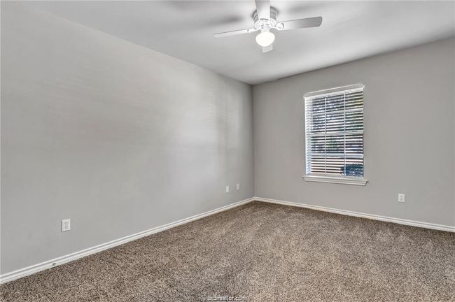 Spare room featuring carpet and ceiling fan | Image 9