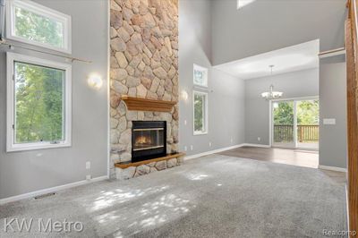 Living room with two story fireplace | Image 2