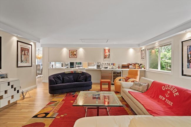 Living area with light wood-type flooring and wine cooler | Image 7