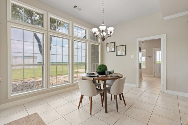 Separate breakfast area with natural light. The door is the entrance to the large utility laundry room and a full bath. | Image 15