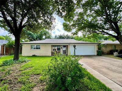 Ranch-style home with a garage and a front lawn | Image 3