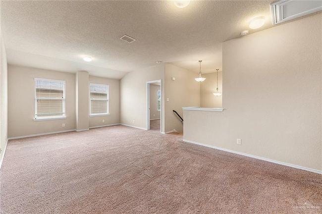 Spare room with light carpet, a textured ceiling, and a smoke detector | Image 20