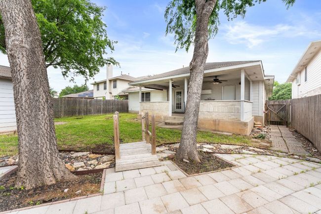 View of front of home featuring ceiling fan, a fenced backyard, and a front yard | Image 31