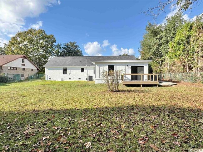 Rear view of house featuring a deck and a fenced backyard | Image 35
