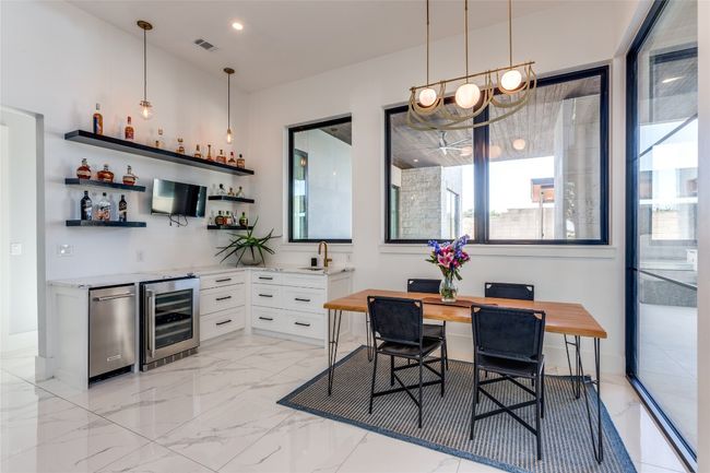 Dining room with wine cooler, and indoor wet bar | Image 12