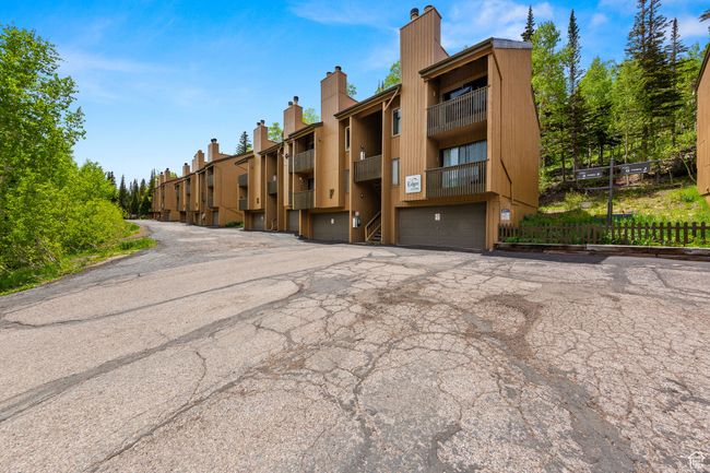 View of property featuring a garage and driveway | Image 22