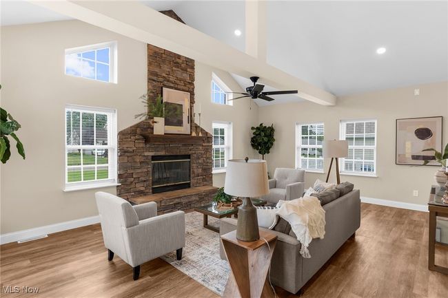 Living room featuring high vaulted ceiling, a fireplace, ceiling fan, wood finished floors, and recessed lighting | Image 13