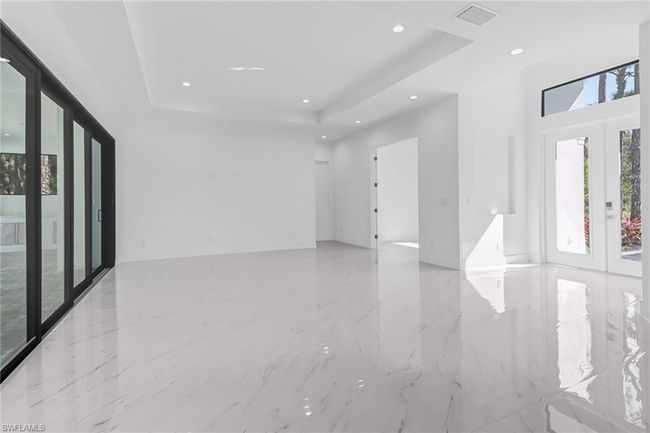 Unfurnished room featuring light tile patterned flooring, french doors, and a raised ceiling | Image 10