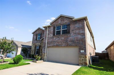 View of property featuring cooling unit and a garage | Image 3