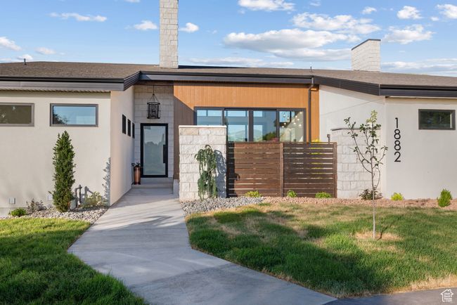 View of front facade with a chimney, a front yard, roof with shingles, and stucco siding | Image 7