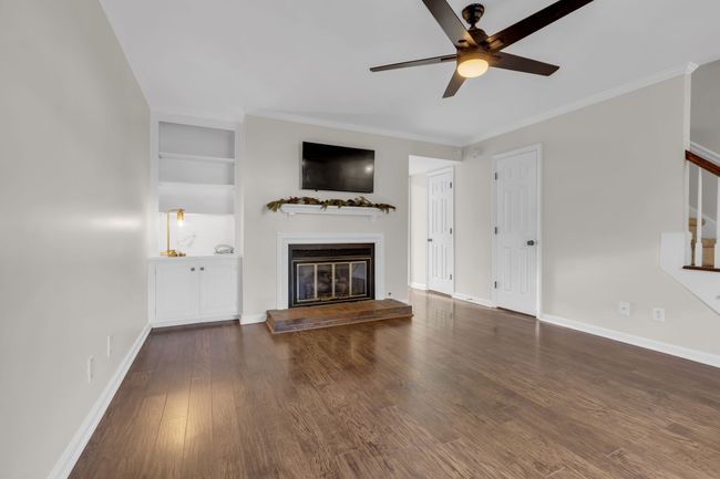 Living room with built-ins and gas burning fireplace. | Image 6