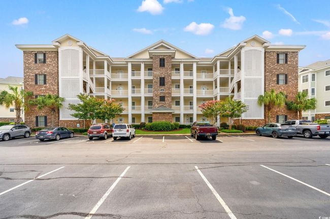 View of building exterior featuring uncovered parking | Image 28