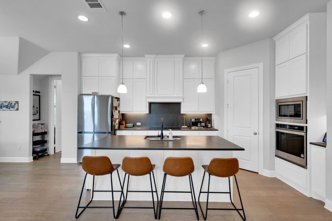 Island area featuring barstools for in eating kitchen area | Image 8