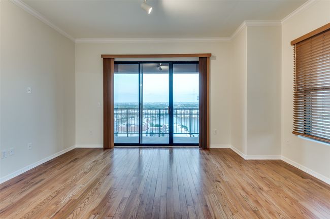 Freshly painted condo with gleaming hardwood floors complemented by abundance of natural light. | Image 19