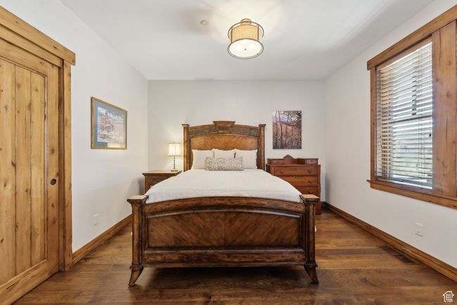Bedroom featuring baseboards and dark wood-type flooring | Image 22