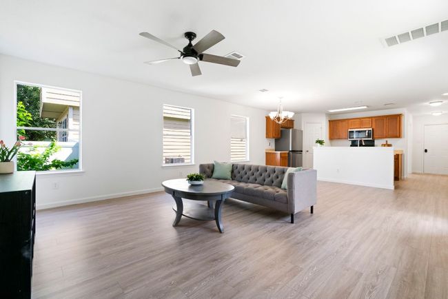 With its seamless flow into the dining and kitchen areas, this living room is ideal for both everyday living and entertaining | Image 15