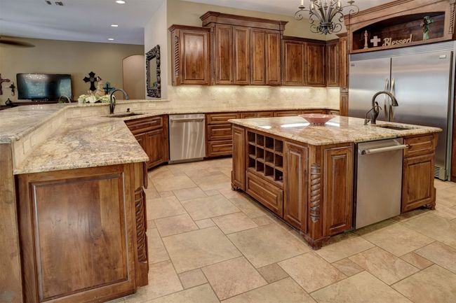 Kitchen boasts high end appliances with 48" Thermador duel fuel range with gas cooktop and griddle. Range has two electric ovens. There is an additional built-in wall Thermador oven. Two dishwashers. Built-In Microwave. Built-In Refrigerator/Freezer. Ice Maker. Two sinks. Pot filler over range. Gorgeous center island. And the Counter space is endless. | Image 6
