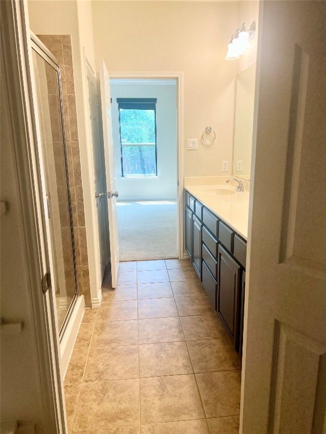 Full bath with a stall shower, vanity, and tile patterned flooring | Image 11
