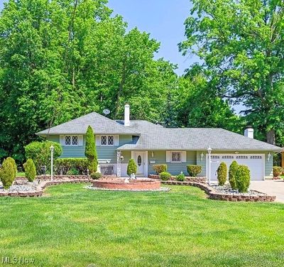 View of Front of Property With Circular Driveway, Pond and 2 Car Attached Garage | Image 1