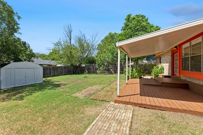 Fenced backyard featuring a storage shed and a wooden deck | Image 22