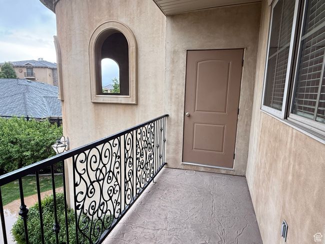 Doorway to property with a balcony and stucco siding | Image 10