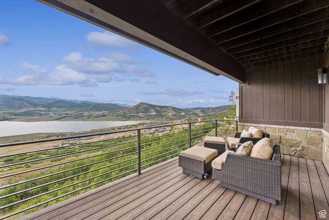 Wooden deck with a water and mountain view | Image 55