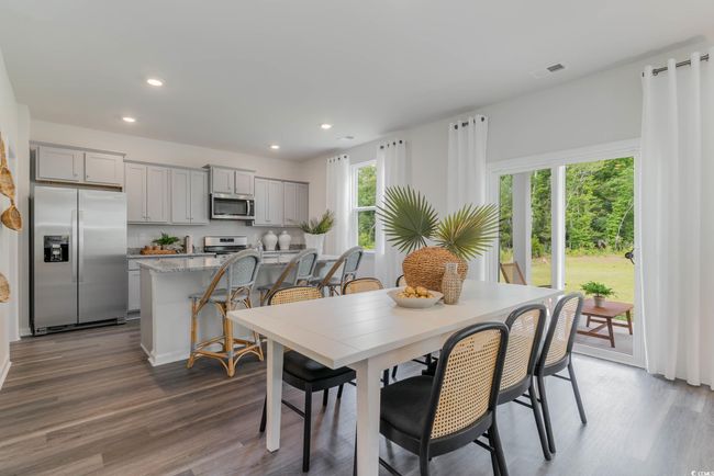 Dining space with wood finished floors and recessed lighting | Image 11