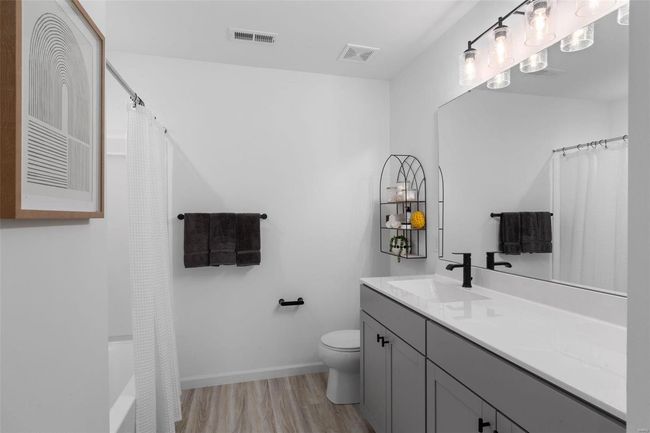 Bathroom with wood-type flooring, vanity, and toilet | Image 21