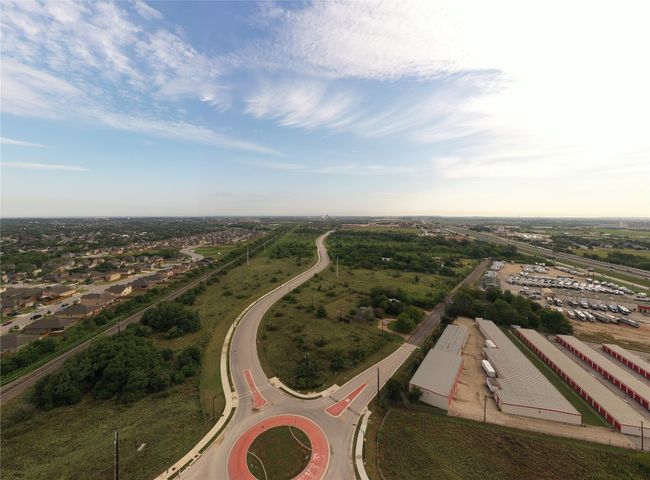 Aerial view of round-about at Marketplace Ave & Burleson St. subject property and surrounding land | Image 33