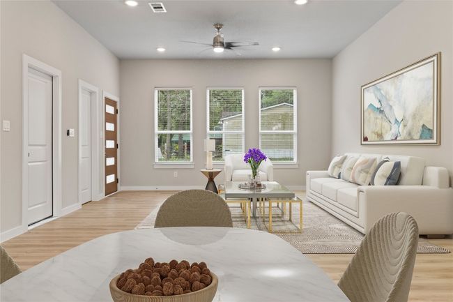 An inviting open floor plan seamlessly connecting the living and dining areas, bathed in gorgeous natural light. (virtually staged) | Image 12