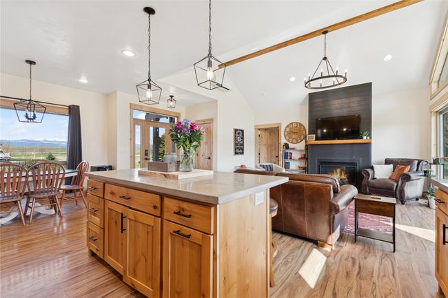 Kitchen with a chandelier, a fireplace, and light wood-style floors | Image 18