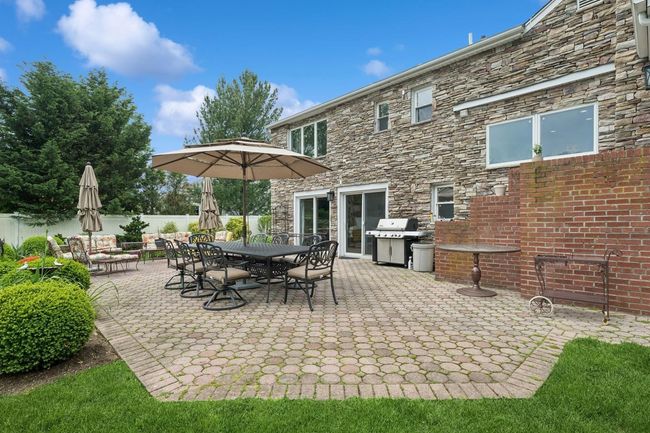 View of patio / terrace featuring a grill, fence, and outdoor dining area | Image 33