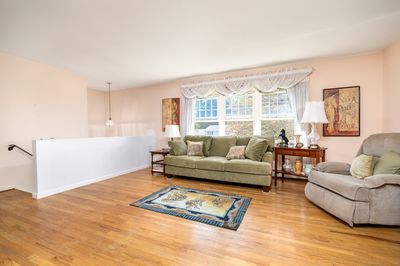 Living room with large windows and hardwood flooring. | Image 2