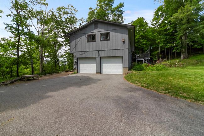 View of home's exterior featuring a yard and asphalt driveway | Image 19