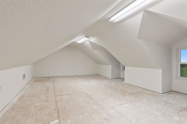 Bonus room with visible vents, a textured ceiling, and lofted ceiling | Image 17