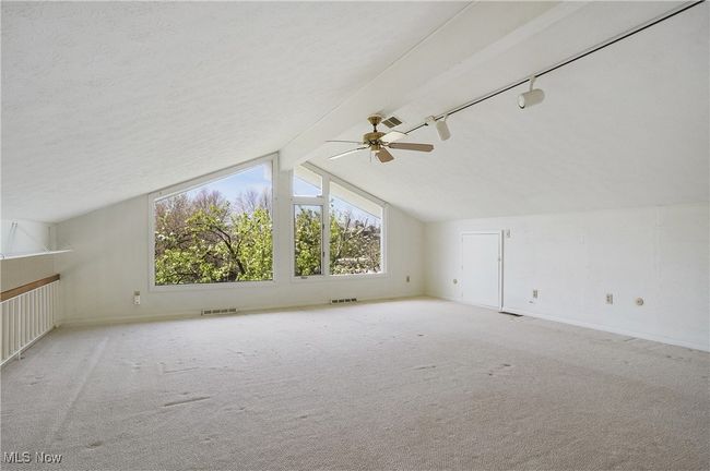 Additional living space featuring visible vents, baseboards, carpet flooring, and ceiling fan | Image 23