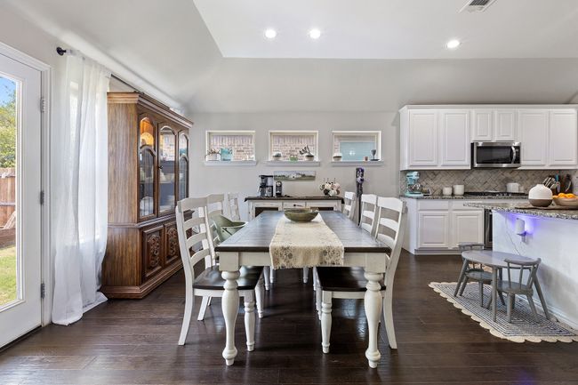 Dining room featuring plenty of natural light, vaulted ceiling, recessed lighting, and dark wood-style flooring | Image 13