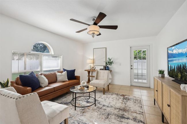 Family room with French Door to the screened in side patio | Image 9