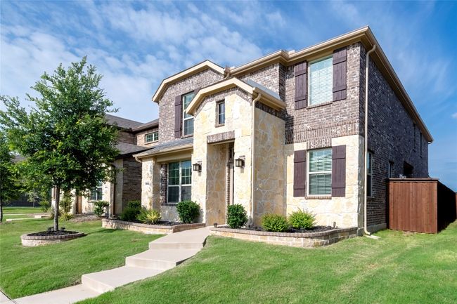 View of front facade featuring stone siding, a front yard, and brick siding | Image 35