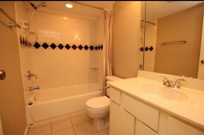 Full bathroom updated with cultured marble countertop, tile floors and designer insets in the tub/shower combo | Image 5