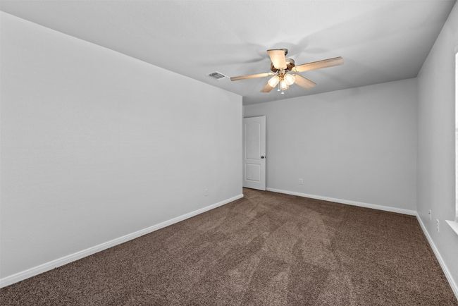 Carpeted spare room with a ceiling fan and baseboards | Image 20