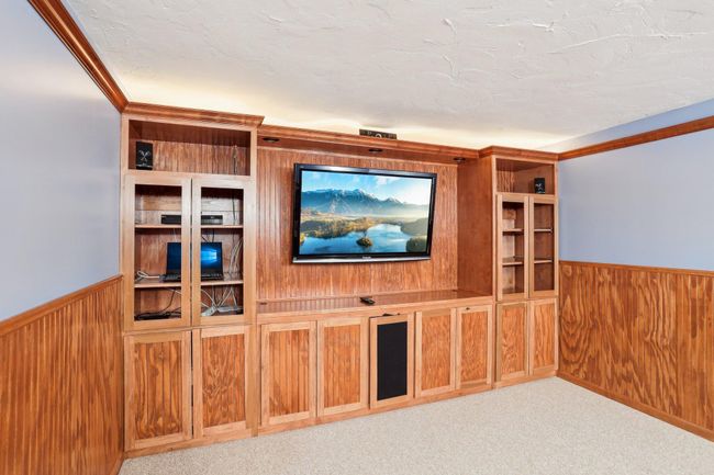 Main floor media room could easily be converted to a main floor bedroom | Image 10