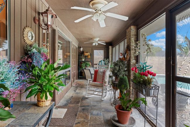 Sunroom featuring stone finish floor and a textured ceiling | Image 20